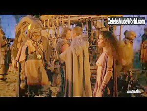 Maria Socas shows her bare breasts in a revealing costume scene from Warrior and the Sorceress (1984).