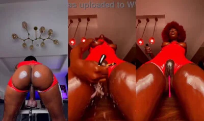 Red afro ebony in red latex works her toys and rides a mounted dildo