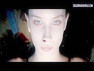 Olwen Catherine Kelly bares her breasts while lying naked on the slab in the morgue scene from The Autopsy of Jane Doe (2016)